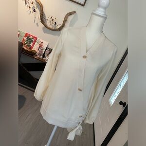 Cream colored blouse with oversized buttons